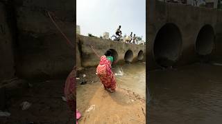 A woman catches fish from a large dam with a hook  amazing fishing in the canal  fishing shorts [upl. by Ennaylloh50]