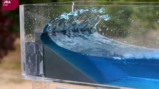 Wave tank demonstration showing the impact of coastal defences on flood risk [upl. by Halehs701]