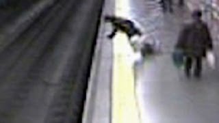 Fainting woman falls on train tracks [upl. by Dnaltroc]