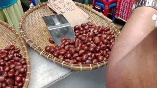 A guy cooking Castañas Chestnuts with back stones in Ongpin Street in Manila Chinatown [upl. by Ennylcaj]