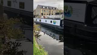 Narrowboat cruising through the swing bridge on Leeds and Liverpool canal at Apperley Bridge canal [upl. by Neidhardt]