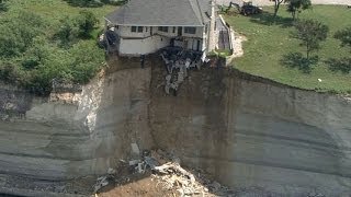 Couple looks on as house falls off cliff [upl. by Nyrhtakyram897]