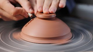 Trimming a Small Indented Stoneware Bowl on the Potters Wheel [upl. by Parthen]