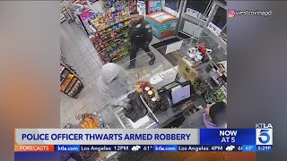 Video captures officer walking into 7Eleven during armed robbery [upl. by Kciregor535]