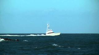 Boats 062820131  Big Sportfishing Boat Enters Rough Inlet with Jumping Spinner Sharks [upl. by Eiramana]