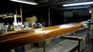 Applying epoxy to wet out the fiberglass on a wooden hull [upl. by Goeger233]