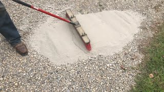 brushing CHEAP concrete onto a gravel driveway adding strength and resilience [upl. by Notliw921]