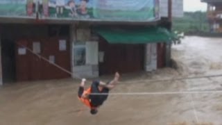 Dramatic footage Man winched across fastflowing river in China after becoming trapped in his home [upl. by Eelyac99]