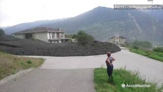 Massive mud flow slams through Swiss town [upl. by Otrebireh]