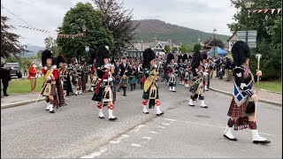 Massed Pipe Bands marching through Braemar to the 2022 Braemar gathering in Royal Deeside Scotland [upl. by Nohsid]