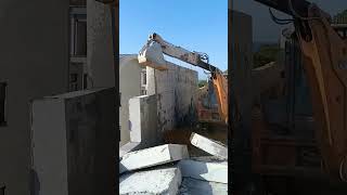 The process of demolishing an aerated concrete block wall with an excavator [upl. by Byers]