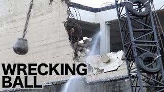 Wrecking ball in action demolishing a concrete building [upl. by Cavil879]