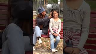 Kind woman helps little girl tie her hair shorts [upl. by Wentworth]