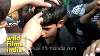 Young Shiite Muslim boy cries as an elder makes a cut on his forehead during Muharram [upl. by Roumell177]