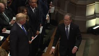 George W Bush sneaks candy to Michelle Obama at Bush funeral [upl. by Elvyn]