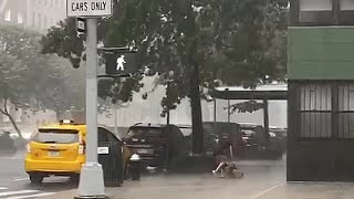 Unfortunate woman gets totally soaked during New York City downpour [upl. by Kare]