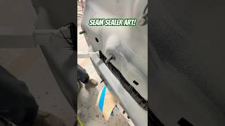 Laying seam sealer on this BMW after replacing the rear body panel seamsealer autobody collision [upl. by Ahsenre]