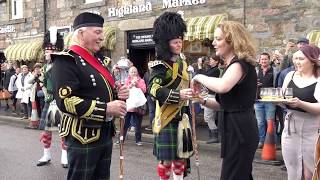 Scottish Pipe Bands parade through Tomintoul Speyside with some Scotch Whisky hospitality [upl. by Sabine649]