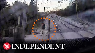 Highspeed train narrowly misses pedestrian crossing tracks after ignoring warnings [upl. by Nailil]