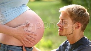 Soon to be father kissing his pregnant wifes baby belly Stock Footage [upl. by Verdie]