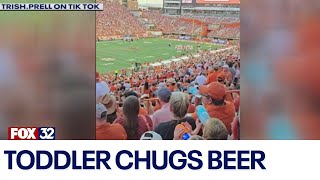 Across America Toddler spotted chugging beer at college football game [upl. by Brill]