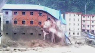 Buildings collapse into raging floodwaters in China [upl. by Pfeifer]