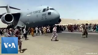 Afghans Try to Flee at Kabul Airport [upl. by Kriste]