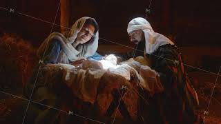 Mary and Joseph caressing baby Jesus in illuminated manger [upl. by Eceertal934]