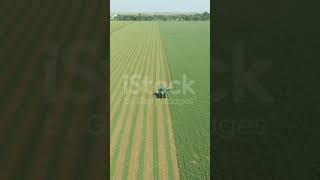 Above view dolly move on tractor as pulling grass cutting machinery over field of [upl. by Ahsemac898]