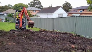 Mini Excavator excavating levelling and reshaping the yard [upl. by Amles666]