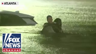 FOX Weather reporter rescues woman from car as floodwaters rise [upl. by Cyrano431]