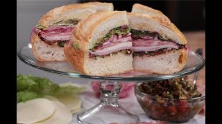 Andrew Zimmern Cooks Muffuletta Sandwich [upl. by Aliemaj]