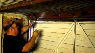 How to adjust the spring tension on a garage door in Manchester [upl. by Zinck]