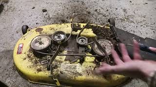 how to take a mower deck off and put a new belt on a John Deere L110 riding lawn mower 42inch deck [upl. by Aihtnys]