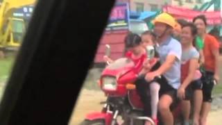 Overload Motorbike with eight passengers drives along road in China [upl. by Ennirac70]