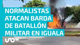 Normalistas de Ayotzinapa lanzan petardos y estrellan vehículo contra barda de la zona militar [upl. by Ymma]