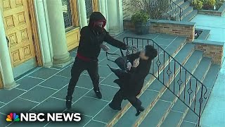 Surveillance video shows a woman attacked and robbed outside a New York City church [upl. by Ahsekal]