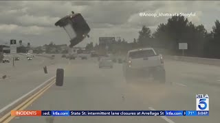 Runaway tire sends car flying into the air [upl. by Ayrotal]