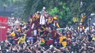 Watch Filipino Catholics climb onto statue of Jesus [upl. by Sulokcin]