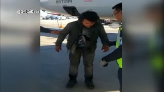 Man apprehended after emerging from wheel well of airplane [upl. by Ajnot185]