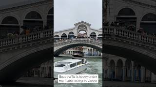 Boat traffic is heavy under the Rialto Bridge in Venice [upl. by Durward]