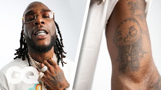 Burna Boy Breaks Down His Tattoos  GQ [upl. by Einnim]