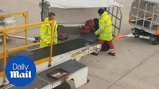 Manchester Airport staff carelessly THROW baggage onto cart [upl. by Paloma]